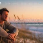 Man sitting outdoors at sunset, reflecting on opioid recovery and hope.